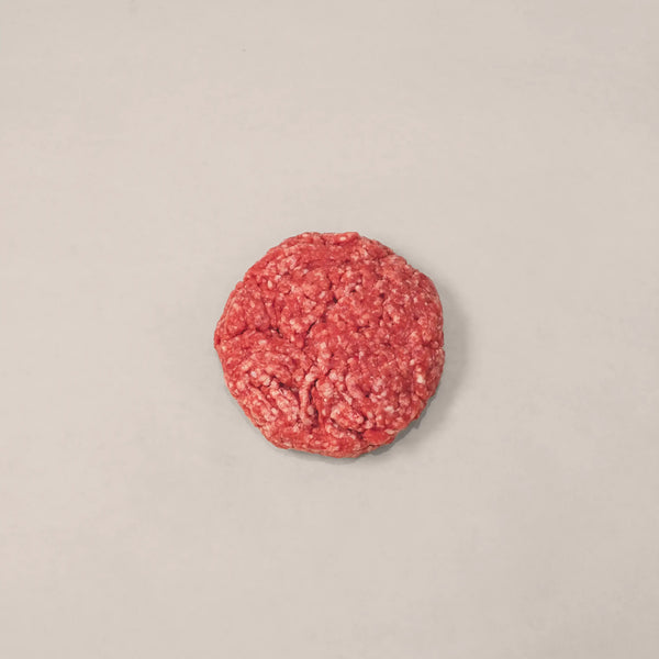 Raw hand-formed beef patty made from 100% premium Canadian beef for a flavorful burger experience.