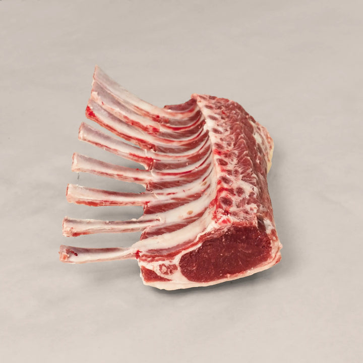 Artisan Rack of Lamb, hand-trimmed, showcasing tender meat and exquisite quality, perfect for gourmet dining.