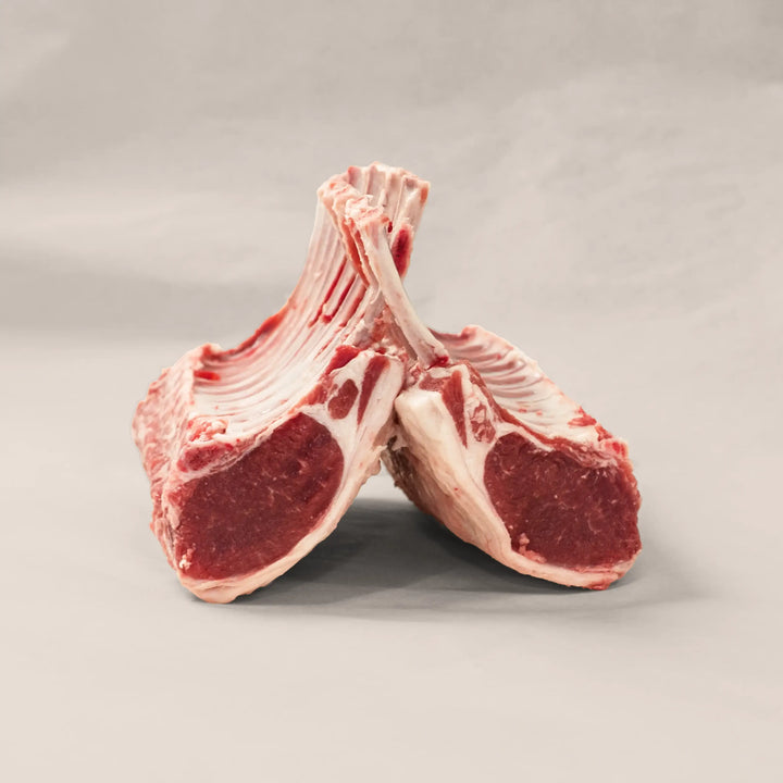 Artisan rack of lamb showcasing hand-trimmed quality and elegant marbling, perfect for gourmet dining.