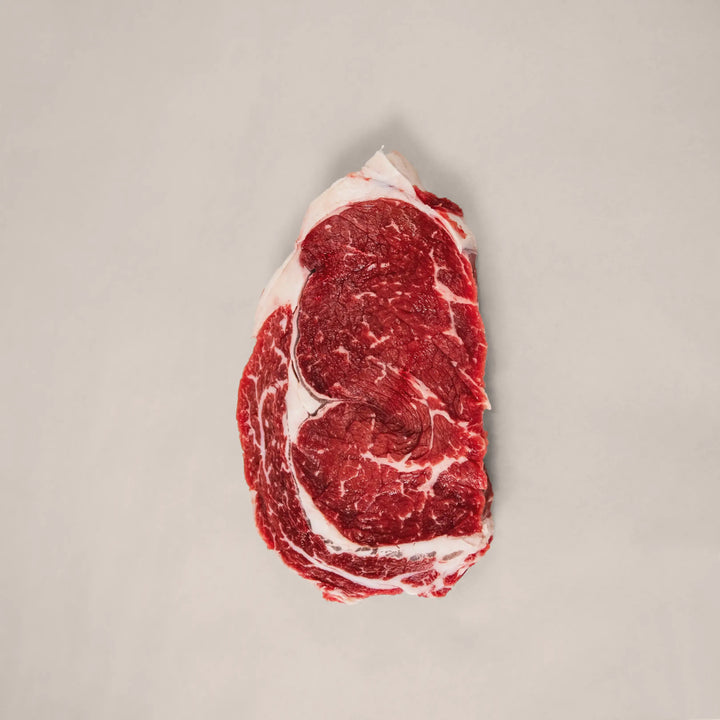 Well-marbled ribeye steak cut from the rib primal of premium Canadian beef – rich, juicy, and perfect for cast-iron or open-flame cooking top view