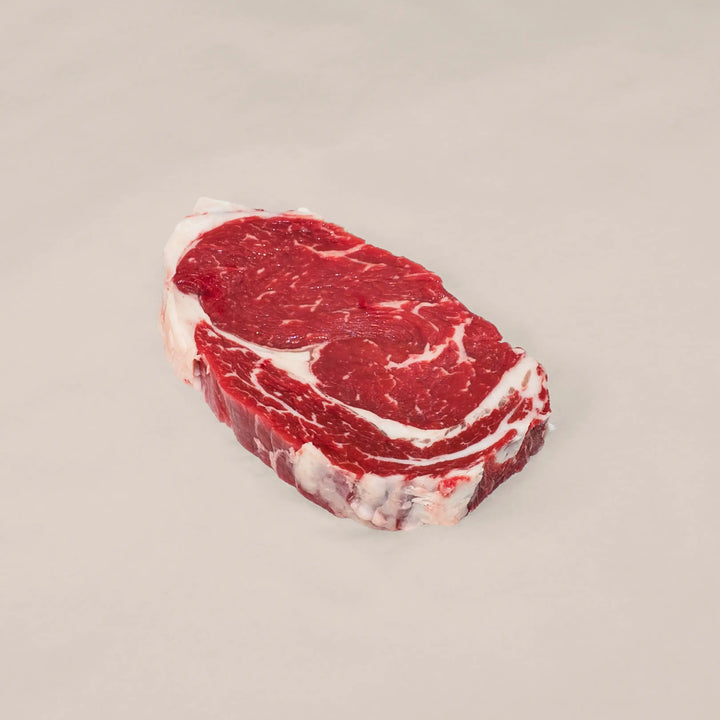 Well-marbled ribeye steak cut from the rib primal of premium Canadian beef – rich, juicy, and perfect for cast-iron or open-flame cooking top view