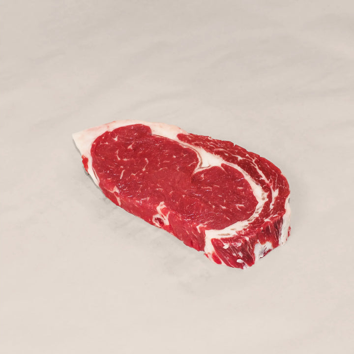 Well-marbled ribeye steak cut from the rib primal of premium Canadian beef – rich, juicy, and perfect for cast-iron or open-flame cooking top view