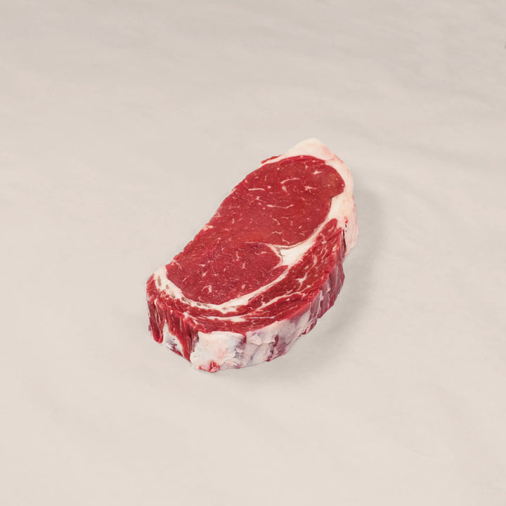 Well-marbled ribeye steak cut from the rib primal of premium Canadian beef – rich, juicy, and perfect for cast-iron or open-flame cooking top view