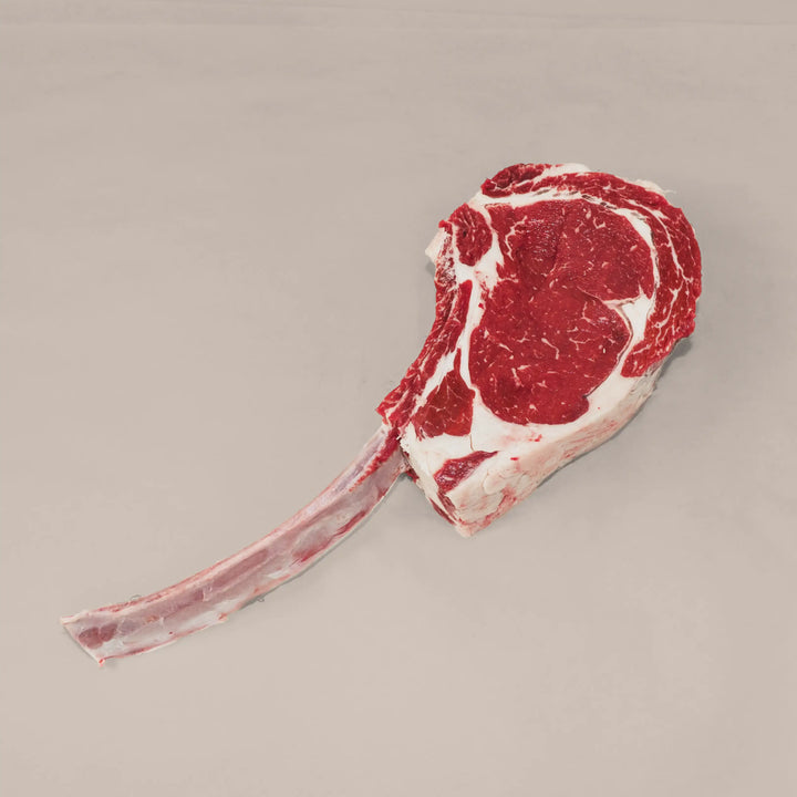 Heavy Duty Beef Tomahawk Steak, showcasing a marbled cut with a dramatic long bone, perfect for bold flavors and special occasions.