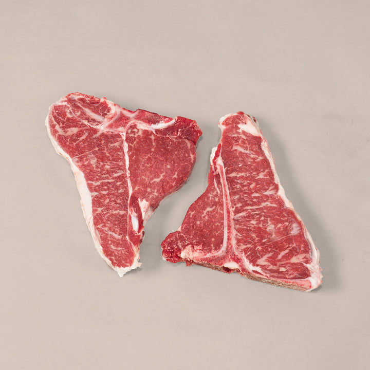 Premium Porterhouse T-Bone Steak showcasing marbling and T-shaped bone, perfect for a delicious meal.